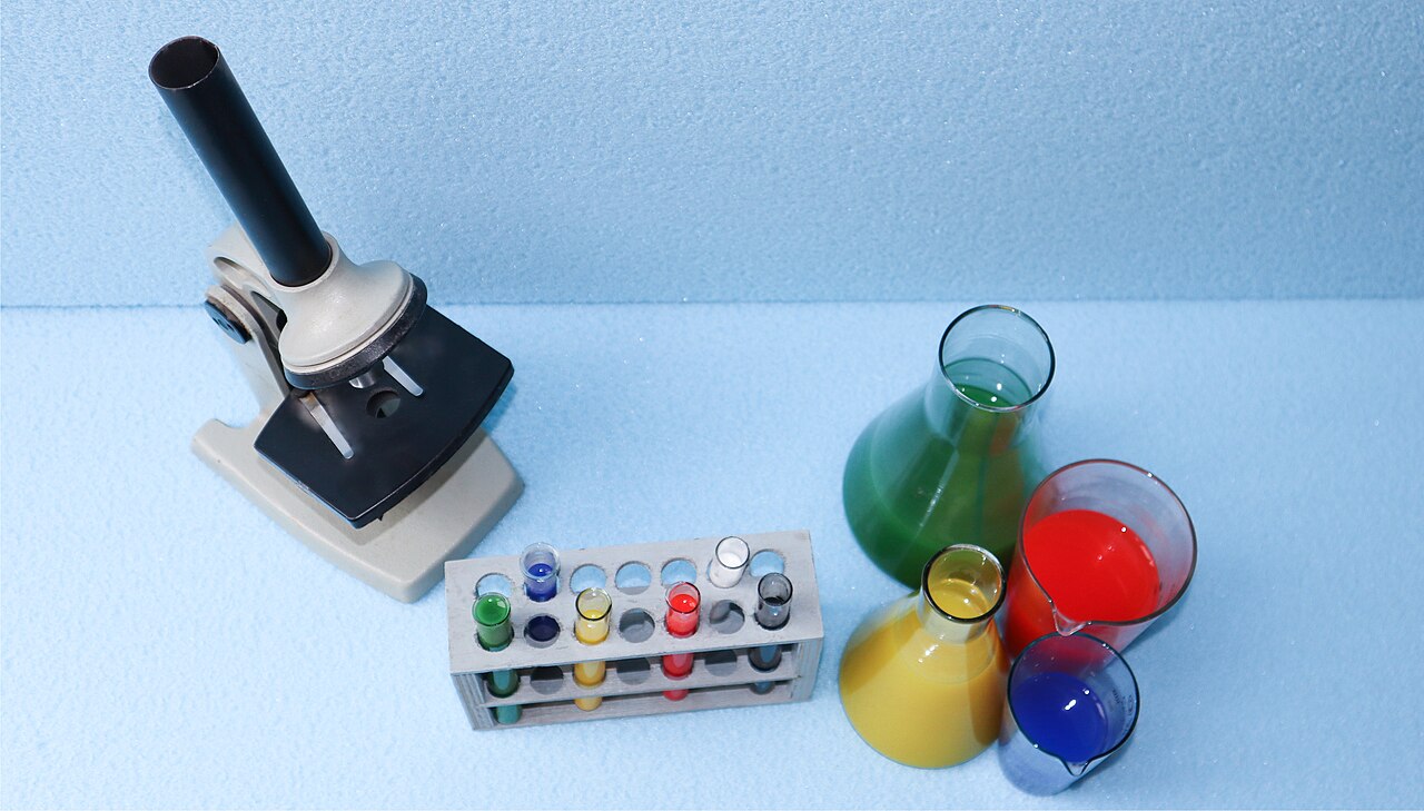 Laboratory glassware and microscope on a bench